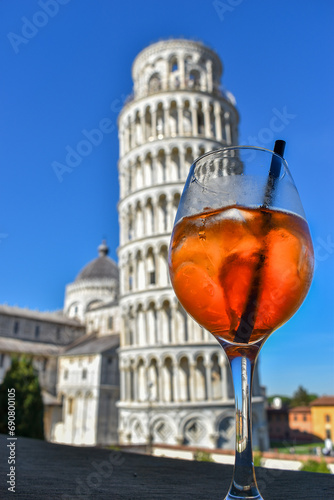 Spritz Cocktail in goblet glass with background landscape with leaning tower of Pisa, Itay on blue sky photo