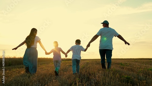 Dad mom, Son daughter run hand in hand with kids. Children parents, full family, children. Happy family of farmers with children running through wheat field, sunset. Family, group of people in nature