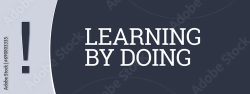 Learning by doing. A blue banner illustration with white text.
