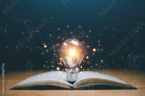 Glowing light bulb on a book, Inspiring from read concept, Educational knowledge and business education ideas, Innovations, self-learning, knowledge and searching for new ideas. Thinking for new idea. photo