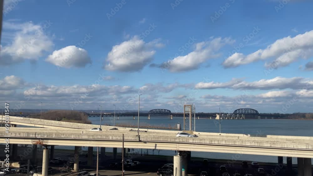 Cars are driving on interstate 64 in Louisville in front of the bridges crossing Kentucky river Cars are driving on interstate 64 in Louisville in front of the bridges crossing Kentucky river
