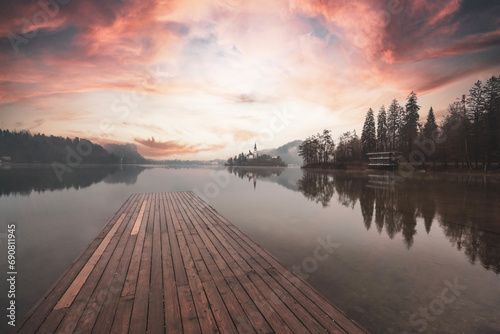 lake bled slovenia sunset clouds and light landscape with reflections photo