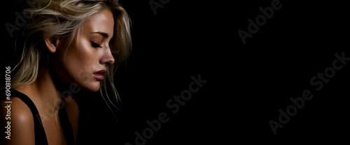 Sad woman with closed eyes on dark background, concept of domestic violence and abuse, with copy space