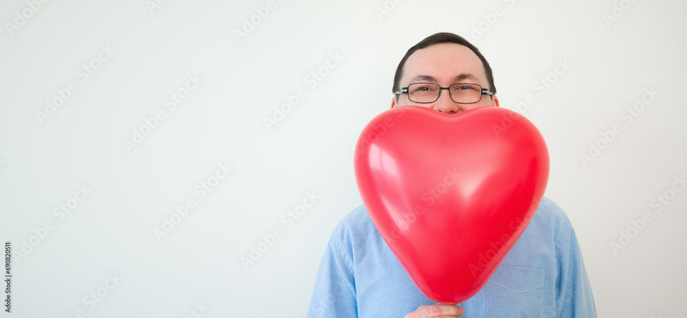 Valentines day banner with place for text. Man hiding behind heart balloon Valentines day banner with place for text. Man hiding behind heart balloon