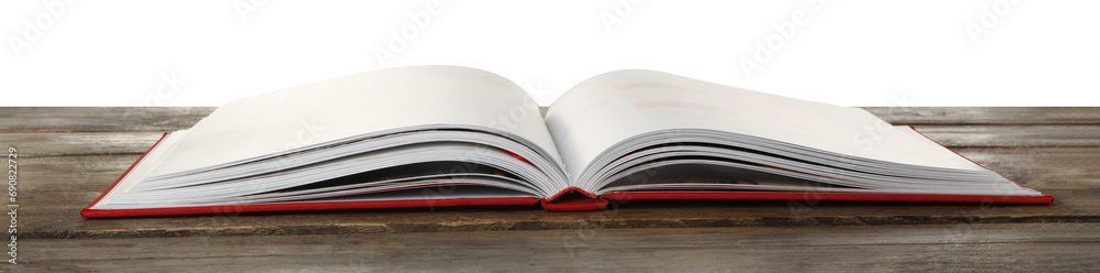 Open book with red cover on wooden table against white background Open book with red cover on wooden table against white background