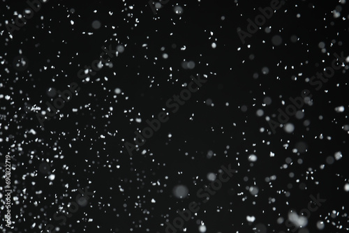 White snow falling down on black background