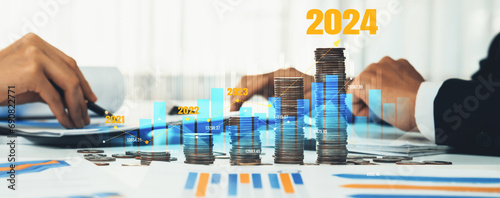 Growth coin stack symbolizing business investment and economic growth. Business people doing financial planning to achieve financial goal and contribute maximum profit on new year 2024 . Shrewd photo