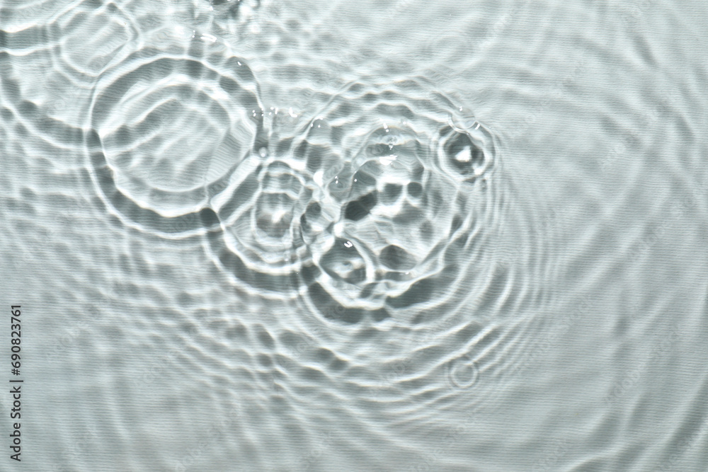Rippled surface of clear water on light grey background, top view