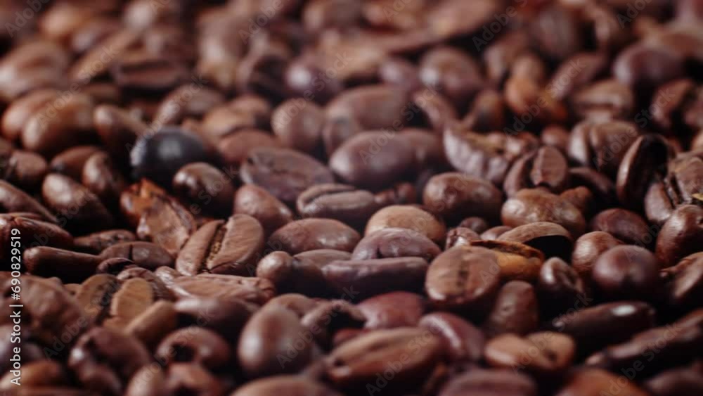Coffee Beans Rotate in a Pile. Close-up of Roasted Coffee Beans.
