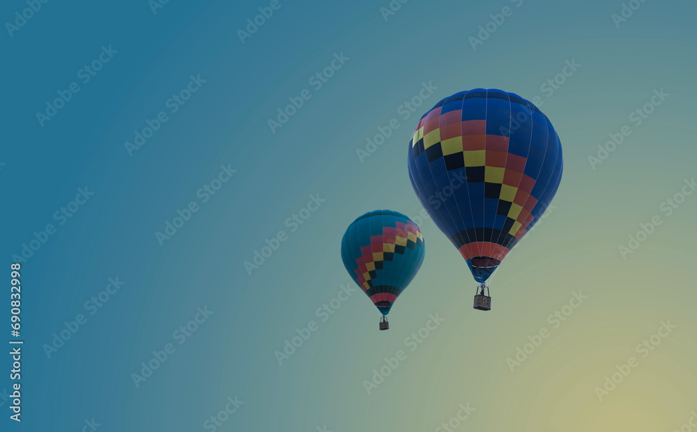 Fototapeta premium Hot air balloons flying at blue sky background - romantic landscape with two colorful balloons. Beautiful travel idea for your vacation..