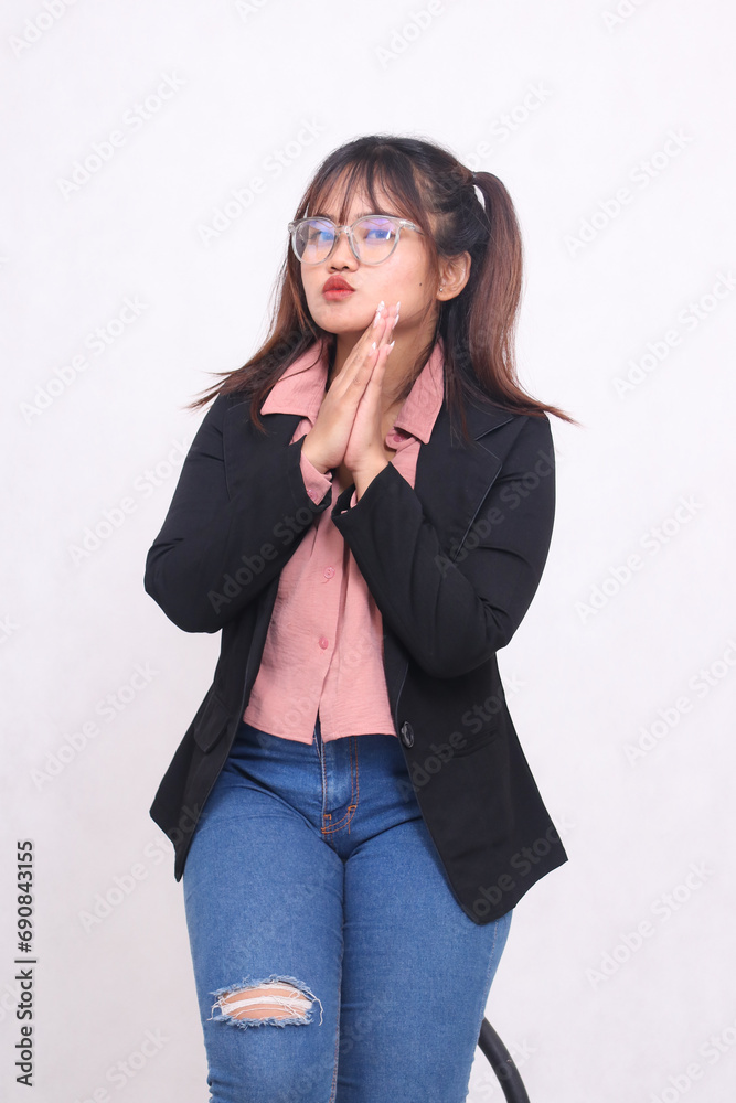 Beautiful elegant Asian Indonesian girl in a casual suit working professionally in an office holding hands kissing on a white background for promotions, advertisements, banners, billboards Beautiful elegant Asian Indonesian girl in a casual suit working professionally in an office holding hands kissing on a white background for promotions, advertisements, banners, billboards