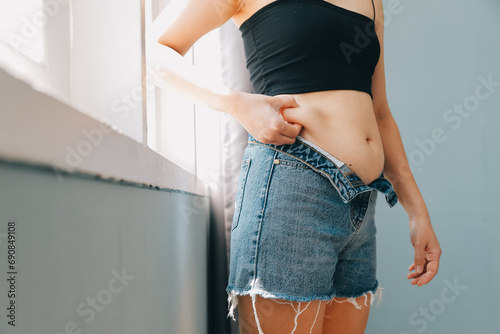 fat woman, fat belly, chubby, obese woman hand holding excessive belly fat with measure tape, woman diet lifestyle concept