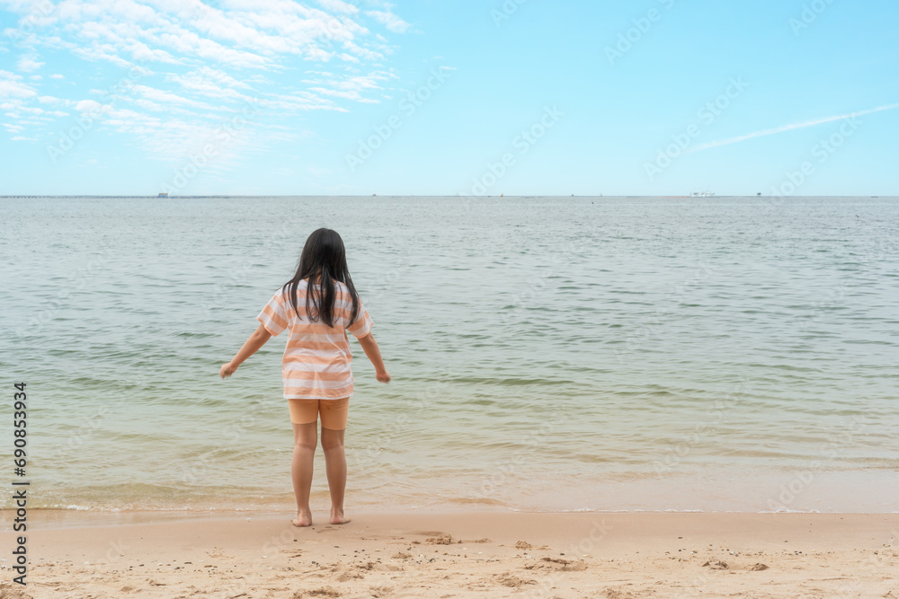 back asian child summer at sea or kid girl standing happy alone on sand beach and daylight blue sky for travel or tourist children to people vacation and holiday relax at pattaya chon buri in thailand back asian child summer at sea or kid girl standing happy alone on sand beach and daylight blue sky for travel or tourist children to people vacation and holiday relax at pattaya chon buri in thailand