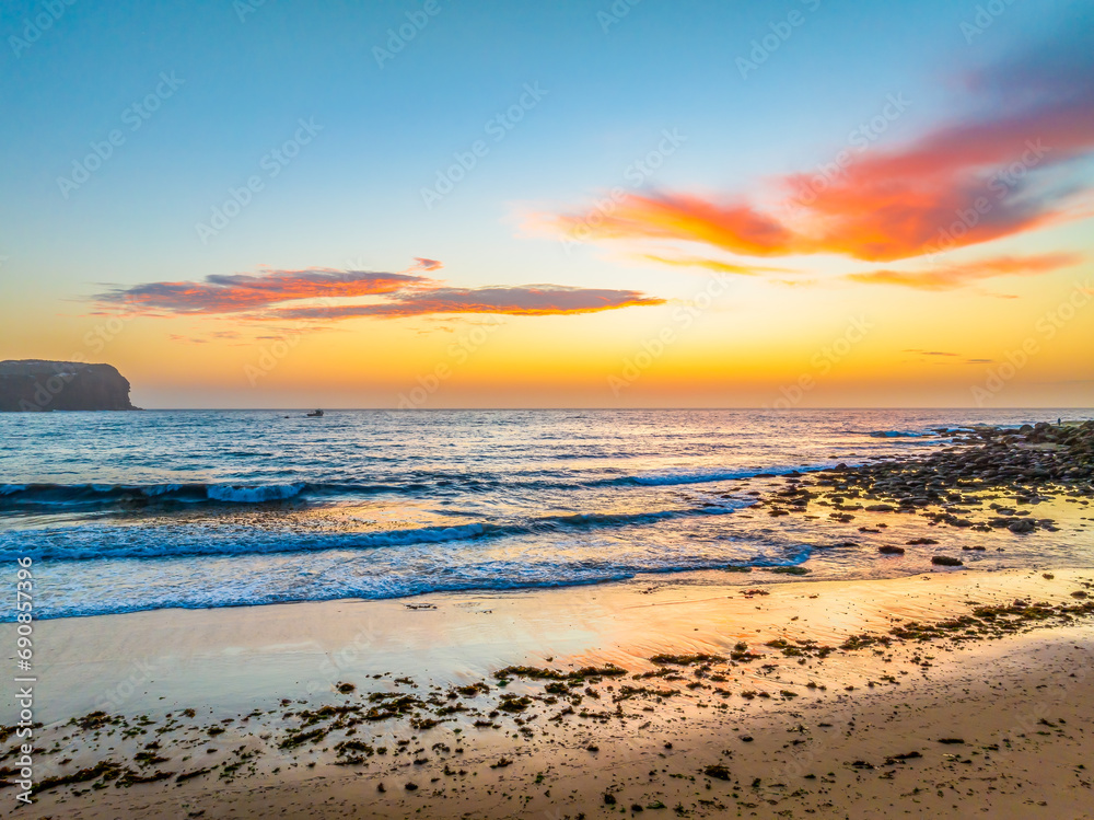 Sunrise at the seashore with colour in the clouds