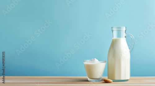 青い背景に木製のテーブルの上に牛乳瓶と牛乳の入ったグラスGenerativeAI photo