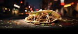 A perspective on a carnitas taco on the street.