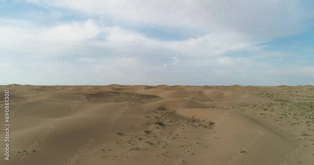 A drone takes off from the surface of the desert on a cloudy day A drone takes off from the surface of the desert on a cloudy day