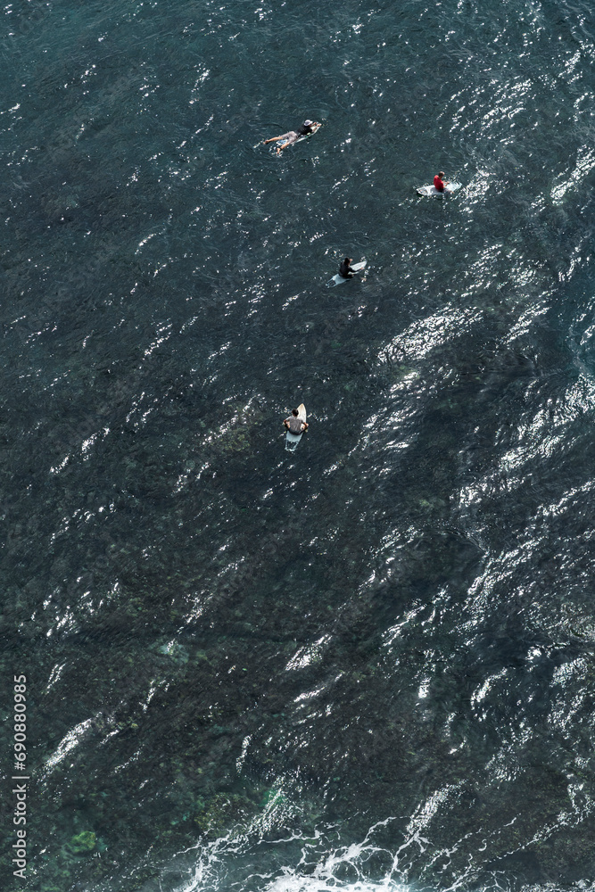 Aerial View: Surfers in the Sea, Indonesia, Asia Aerial View: Surfers in the Sea, Indonesia, Asia