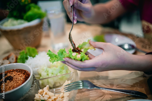Nam Nueng, a Vietnamese dish, is a dish consisting of vegetable dough, salad, raw bananas, chili, garlic, and pork, then topped with a sweet dipping sauce.