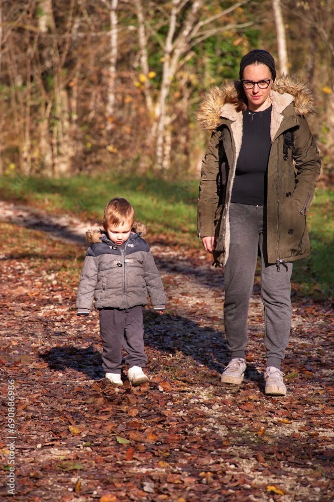 Fototapeta premium Mother with little toddler hiking in the woods
