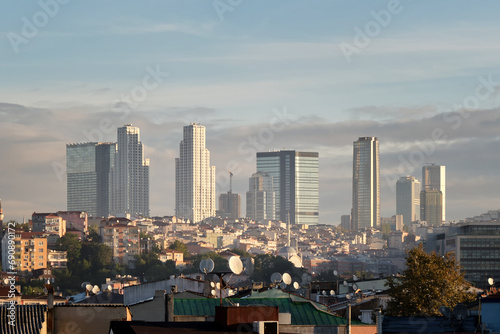 Construction of a new area of the city with skyscrapers and office buildings against the backdrop of old slums.