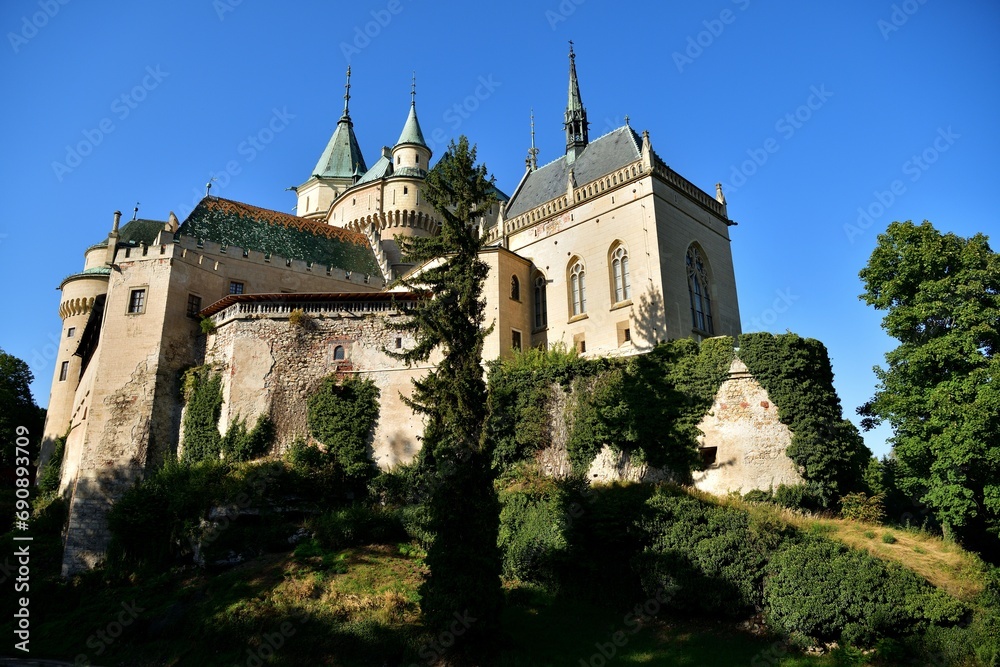 View from behind the trees of the old walls castle Bojnice Slovakia