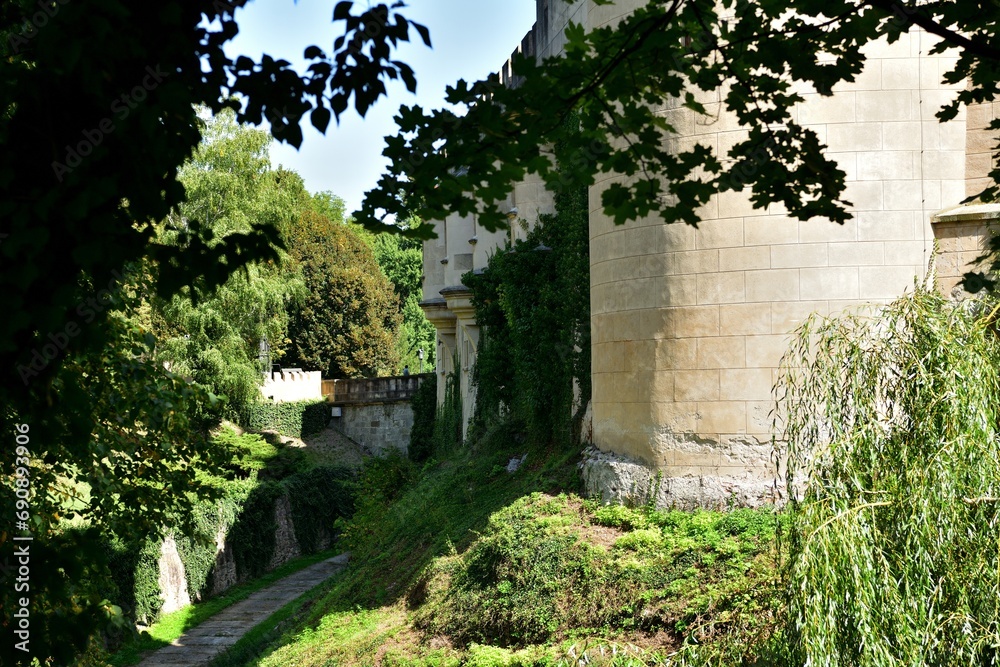 The old walls of the historic castle surrounded by natural water