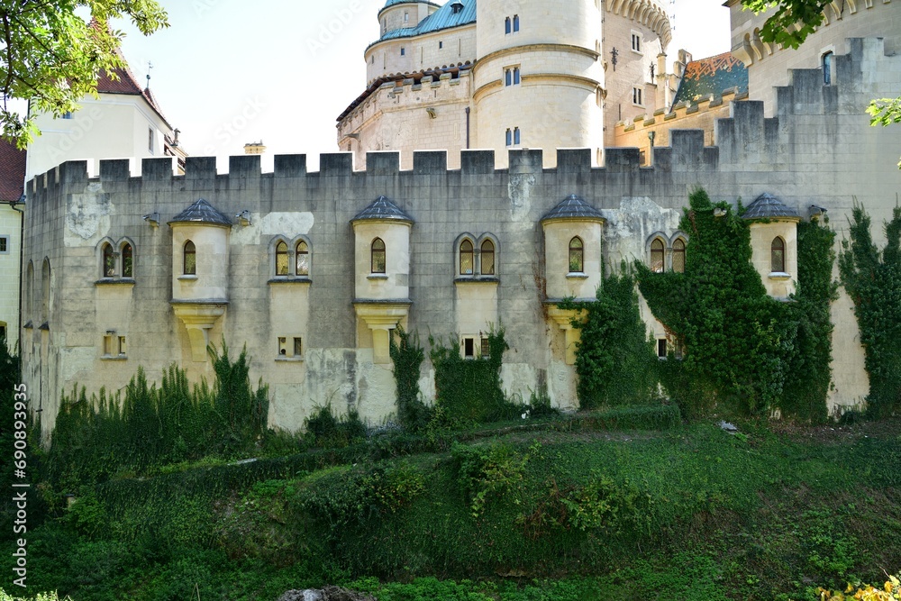 The old walls of the historic castle surrounded by natural water