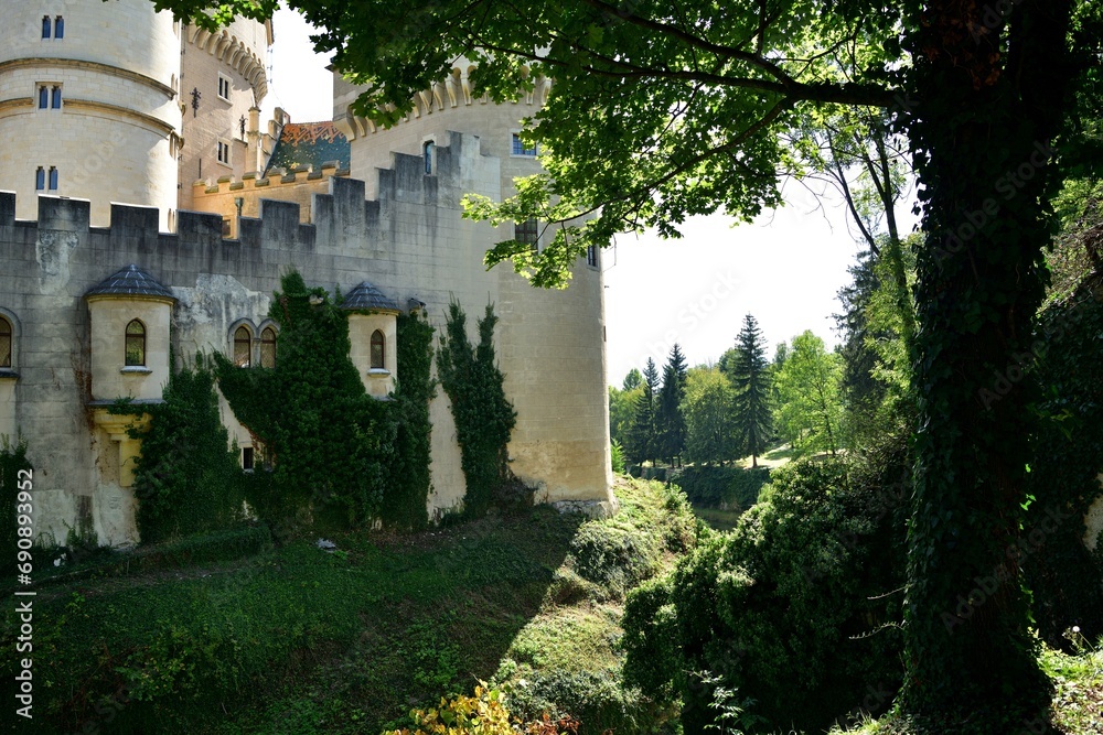 The old walls of the historic castle surrounded by natural water