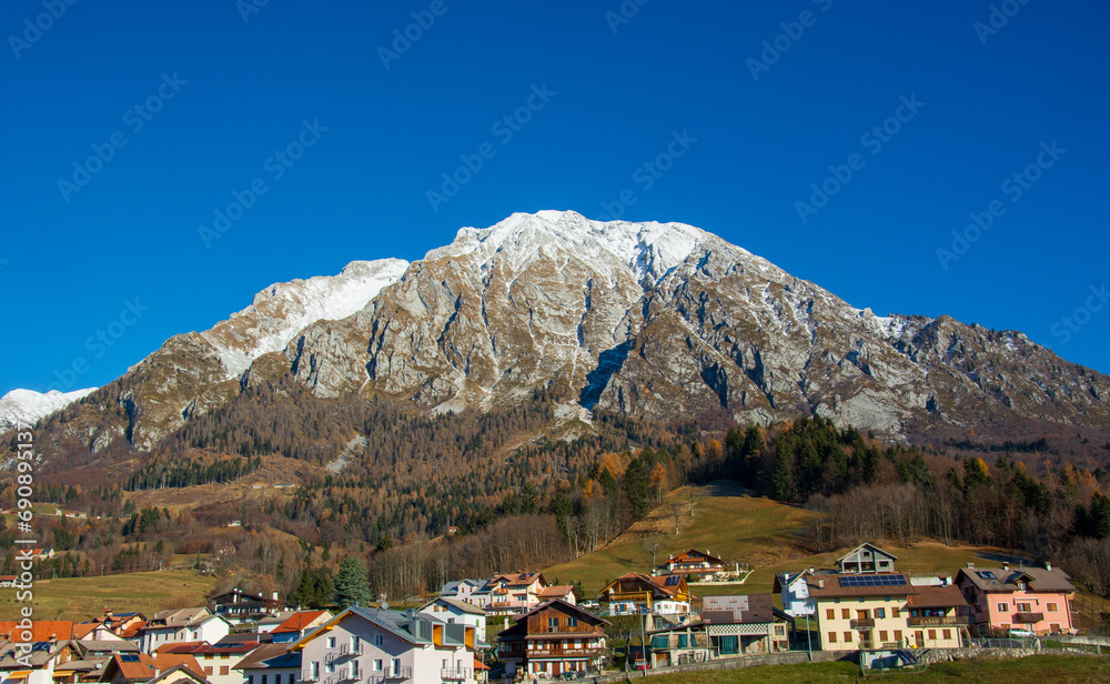 Naklejka premium The small town of San Martino in Alpago in the province of Belluno in the Veneto with the first snow in the mountains