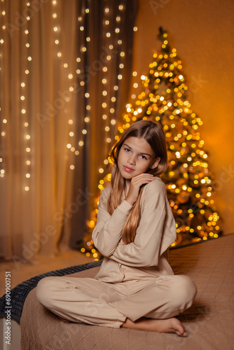 beautiful girl with long hair in pajamas at home waiting for the New Year