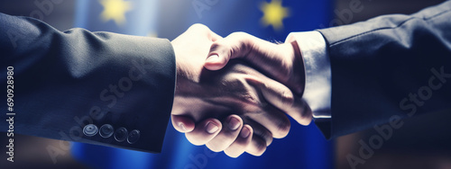 Men shaking hands against flag of European Union, closeup. International relationships photo