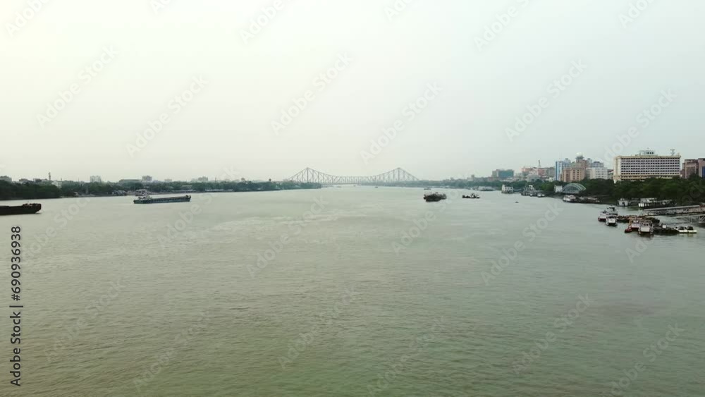   the Hooghly River And Howrah Bridge over the holy river Ganges communicating in between Howrah and Calcutta. British period Bridge.