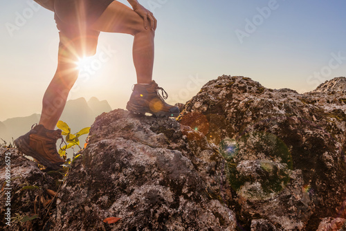 Hiker walking on top mountain sunset background. Hiker men's hiking living healthy active lifestyle.