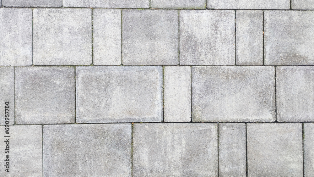 Close up of pebbly gray cement bricks paving a textured road. Close up of pebbly gray cement bricks paving a textured road.