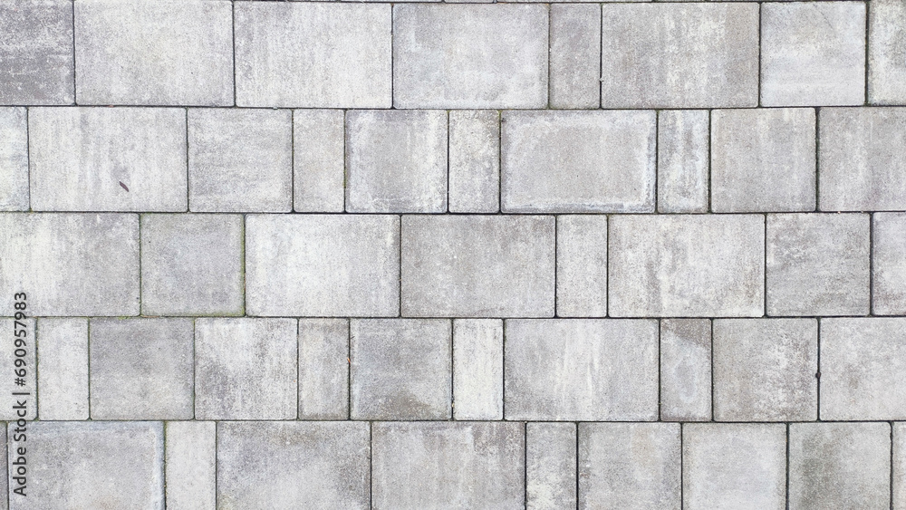  Closeup of a gray stone road with paving texture from cement bricks.