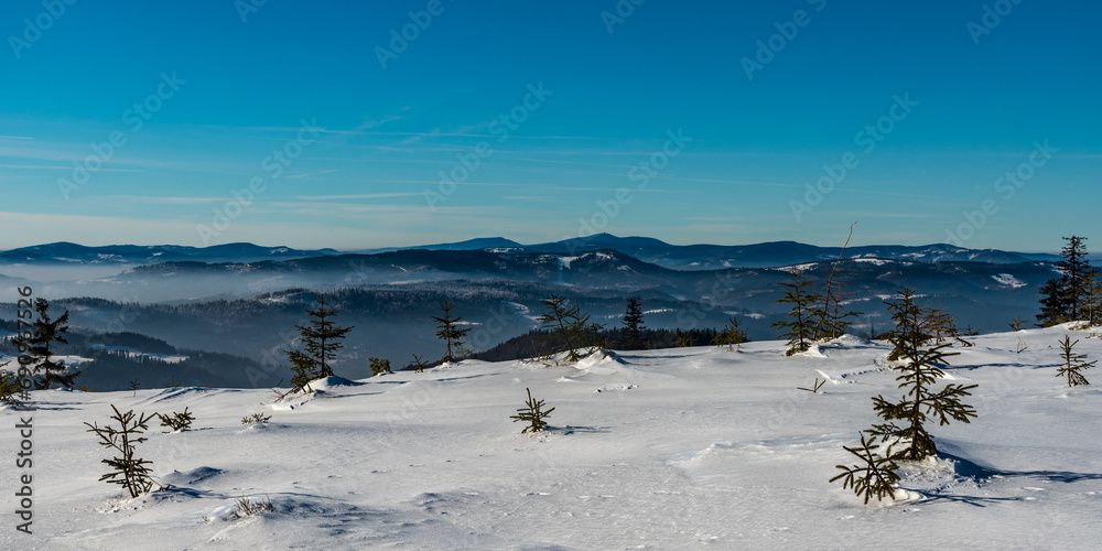 View from hiking trail bellow Magurka Wislanska hill in winter Beskid Slaski mountains in Poland