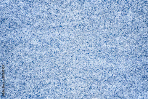 Winter abstract background. Snowflake pattern on a blue background. Macro texture. Natural background. View from above. 