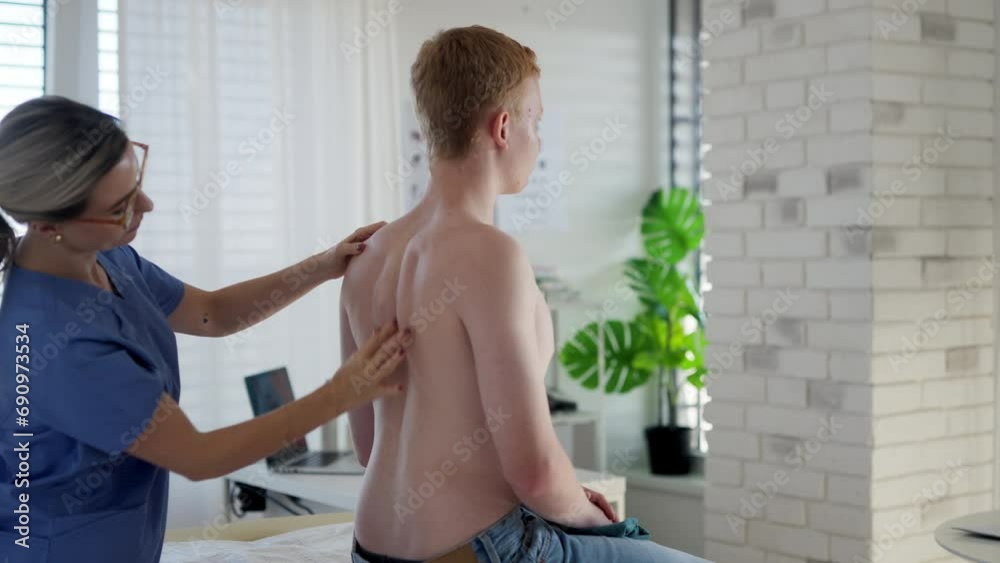 Doctor examining teenage boy's skin, checking acne and moles. Skin cancer screening. Boy visiting dermatologist for annual preventive skin exam. Concept of preventive health care for adolescents. Doctor examining teenage boy's skin, checking acne and moles. Skin cancer screening. Boy visiting dermatologist for annual preventive skin exam. Concept of preventive health care for adolescents.