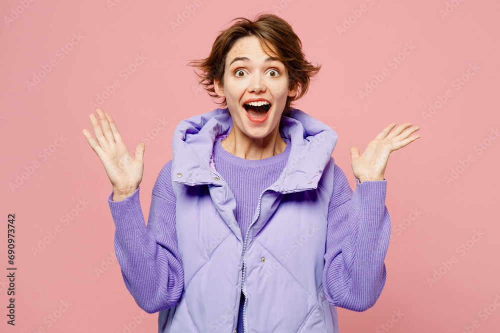 Young shocked amazed fun excited woman she wear purple vest sweatshirt casual clothes look camera spread hands say awesome wow isolated on plain pastel light pink background studio. Lifestyle concept. Young shocked amazed fun excited woman she wear purple vest sweatshirt casual clothes look camera spread hands say awesome wow isolated on plain pastel light pink background studio. Lifestyle concept.