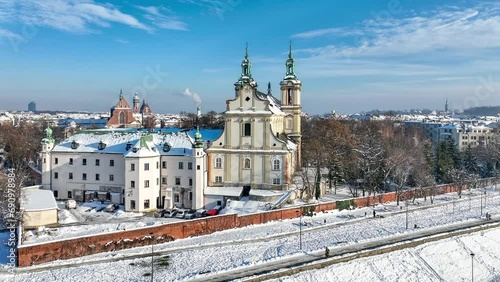 Krakow, Poland. Skalka, St. Stanislaus church na Skałce and Paulinite monastery in snow. Burial place of distinguished Poles. Aerial video in winter,  Boulevards and promenades with walking people photo