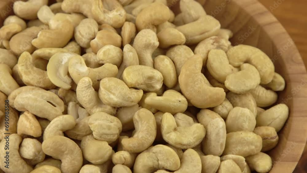 Cashews in a wooden bowl. Nuts are healthy food. Wooden background. Cashew kernel Cashews in a wooden bowl. Nuts are healthy food. Wooden background. Cashew kernel