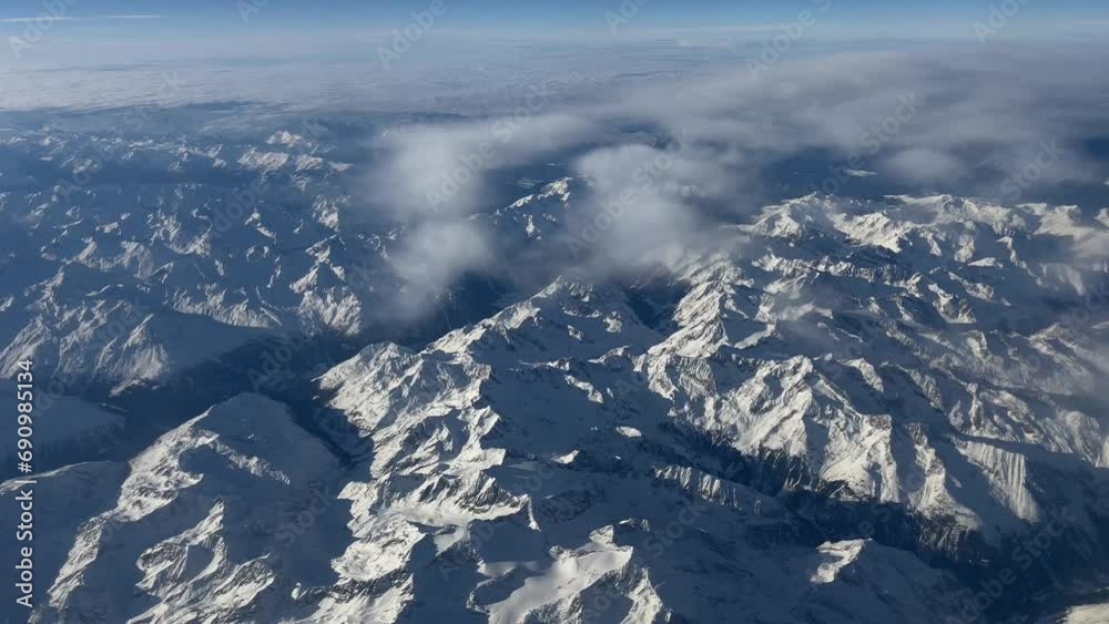 Snow covered mountains in winter, Alps aerial view from the plane Snow covered mountains in winter, Alps aerial view from the plane