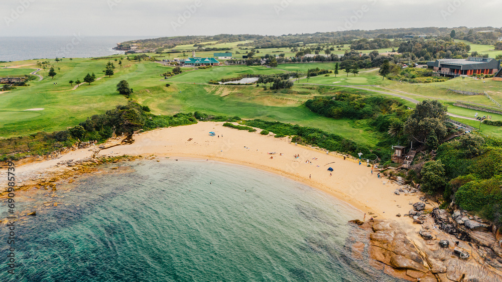 Naklejka premium Aerial view from a drone of Litlle Bay Beach, hidden between rocks and a golf course. Located in Australia, Sydney.