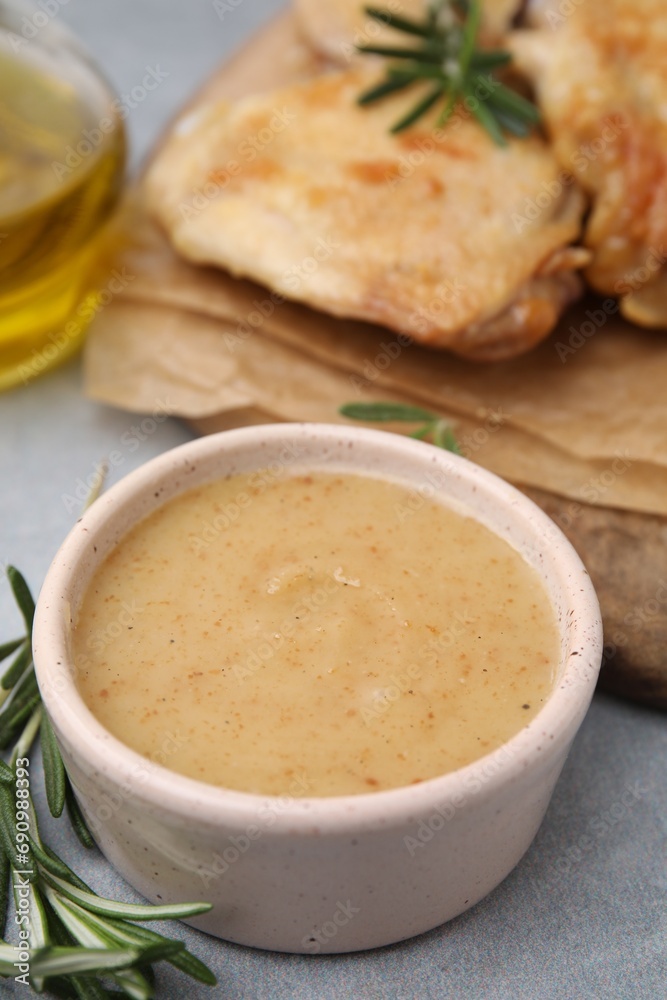 Delicious turkey gravy and rosemary on grey table Delicious turkey gravy and rosemary on grey table