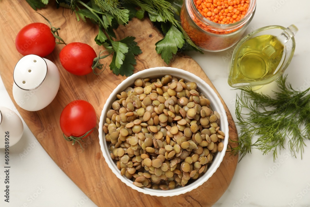 Delicious lentils in bowl served on table, flat lay Delicious lentils in bowl served on table, flat lay