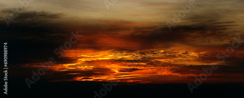 Sunset sky background panorama concept. Top view of horizon Evening sunset sky and morning sunrise in Colorful city with copy space. Empty beautiful sky, panoramic view, tropical bright twilight
