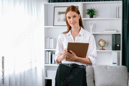 Psychologist woman in clinic office professional portrait with friendly smile feeling inviting for patient to visit the psychologist. The experienced and confident psychologist is utmost specialist