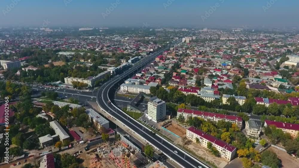 The drone flies over the roads and highways of the city with moving cars. Overcast summer day The drone flies over the roads and highways of the city with moving cars. Overcast summer day