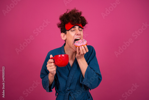 Retro style. A funny curly guy gets ready for his work day early in the morning. Pink background.